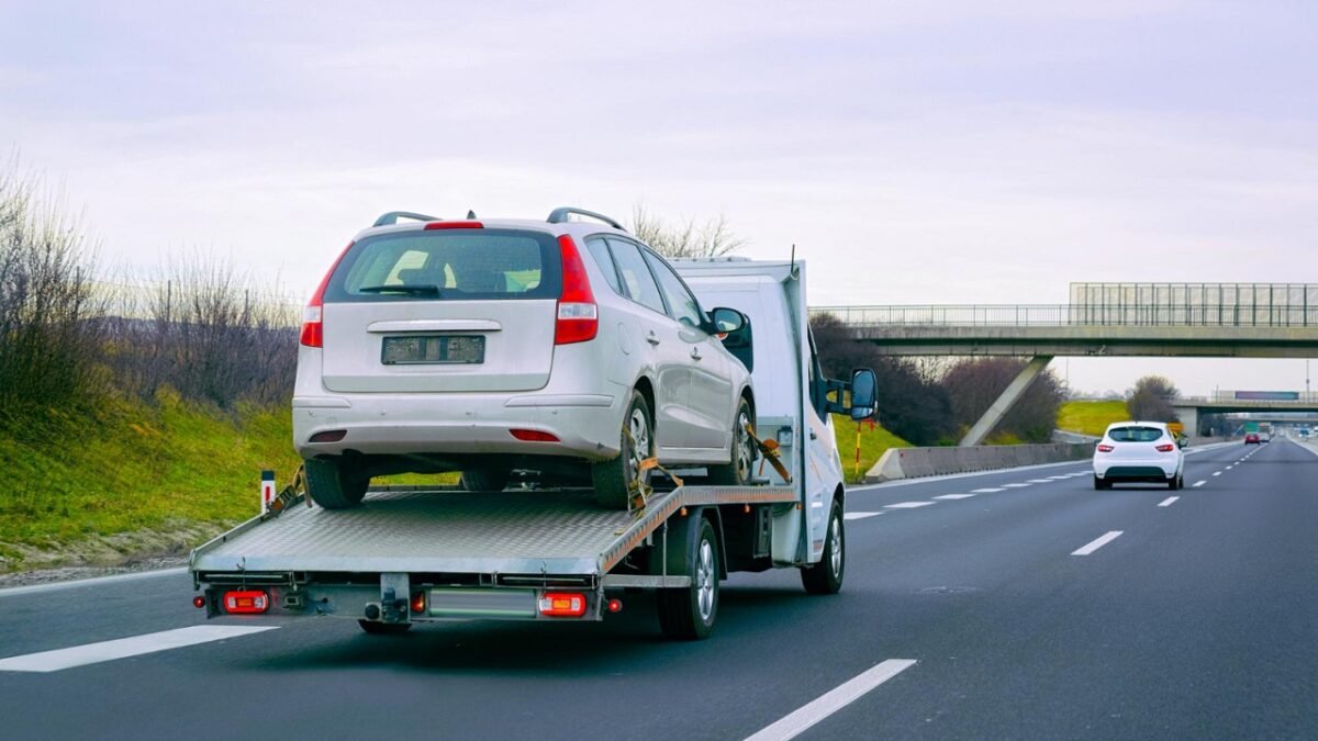 Professional towing service in Bayonne transporting a vehicle safely on the highway.